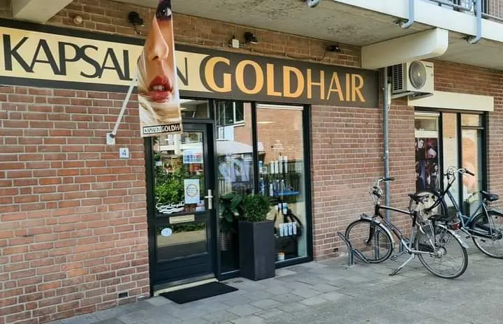 De ingang van Kapsalon Goldhair met fietsen voor de deur
